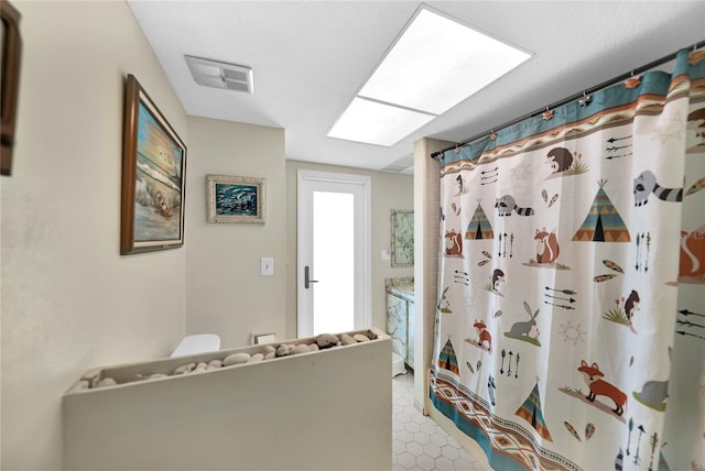 bathroom with a shower with curtain and toilet