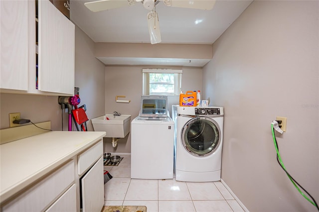 washroom with cabinets, ceiling fan, independent washer and dryer, light tile patterned flooring, and sink