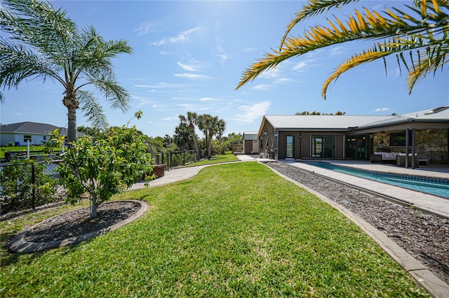 view of yard with a patio area and a fenced in pool