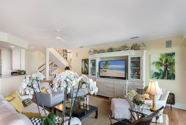 living room with ceiling fan and light wood-type flooring