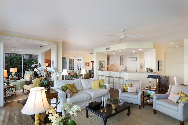 living room featuring hardwood / wood-style flooring and ceiling fan