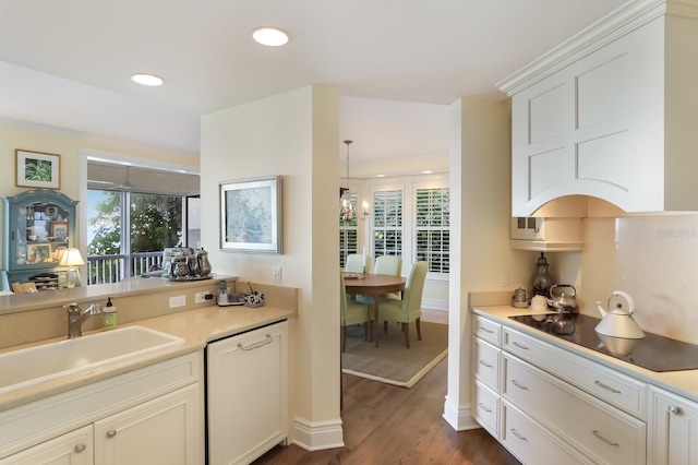 kitchen with decorative light fixtures, sink, dishwasher, black electric stovetop, and white cabinets