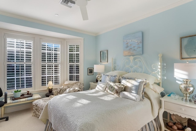 bedroom with carpet floors, crown molding, and ceiling fan