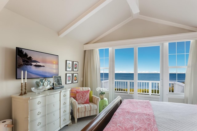 bedroom with a water view, lofted ceiling, and access to exterior