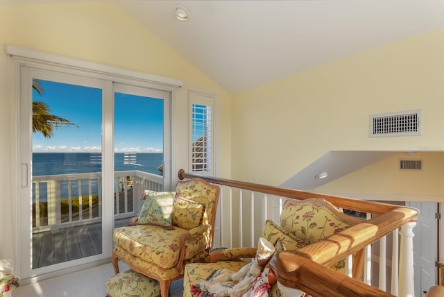 living area featuring a water view and lofted ceiling