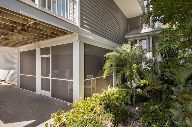 view of home's exterior with a sunroom