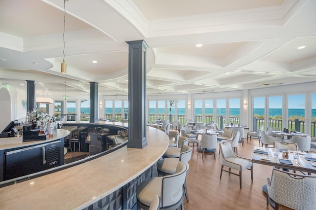 521 Buttonwood Bay Dr, Boca Grande, FL 33921 - bar area featuring decorative columns, coffered ceiling, wood finished floors, a water view, and beamed ceiling