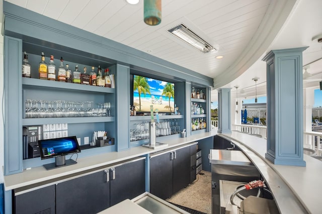 bar featuring wooden ceiling, ornate columns, built in shelves, and decorative light fixtures