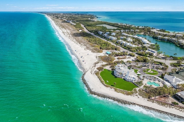 bird's eye view with a water view and a beach view