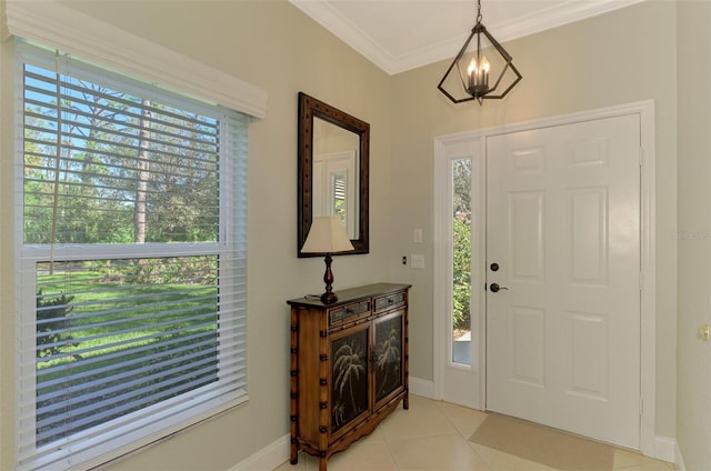 entrance foyer with crown molding, light tile patterned floors, and a chandelier