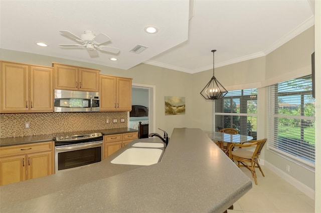 kitchen featuring backsplash, stainless steel appliances, sink, pendant lighting, and light brown cabinets