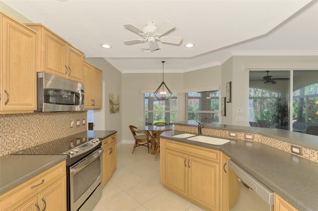 kitchen with sink, stainless steel appliances, tasteful backsplash, pendant lighting, and ceiling fan with notable chandelier