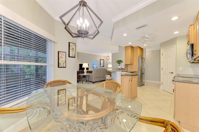 dining room featuring ceiling fan with notable chandelier, crown molding, and light tile patterned flooring