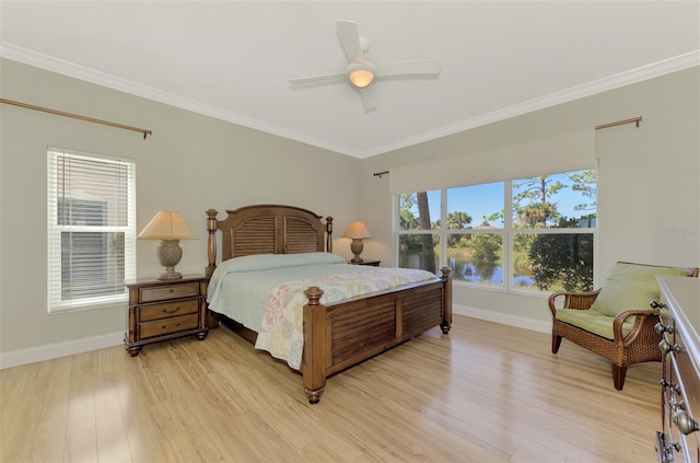 bedroom featuring ceiling fan, light hardwood / wood-style floors, and ornamental molding