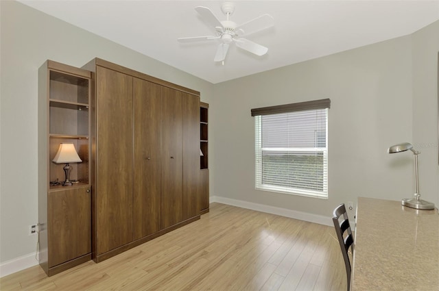 bedroom featuring light wood-type flooring, a closet, and ceiling fan