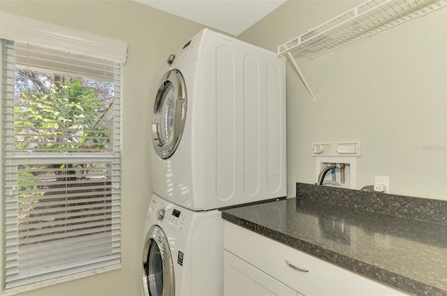 laundry room with stacked washing maching and dryer