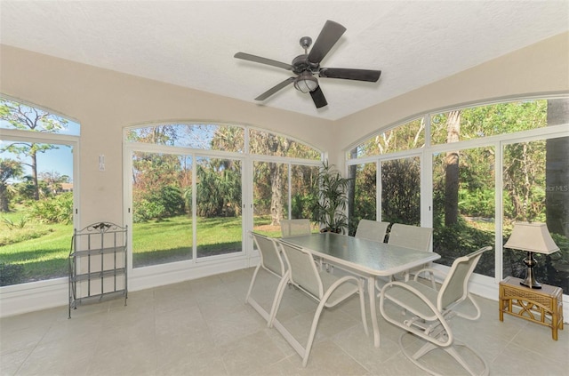 sunroom featuring ceiling fan and a healthy amount of sunlight