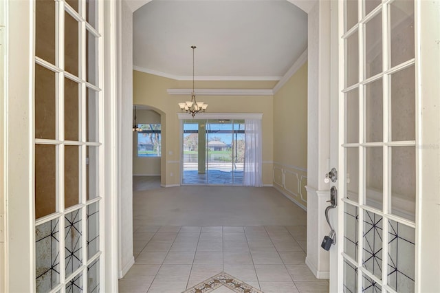 interior space with crown molding and a chandelier