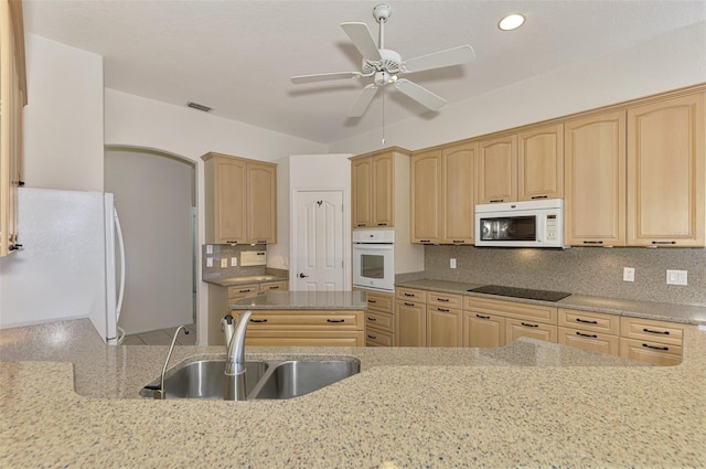 kitchen with tasteful backsplash, ceiling fan, light brown cabinetry, sink, and white appliances