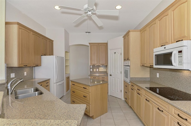 kitchen featuring light brown cabinetry, sink, white appliances, and ceiling fan