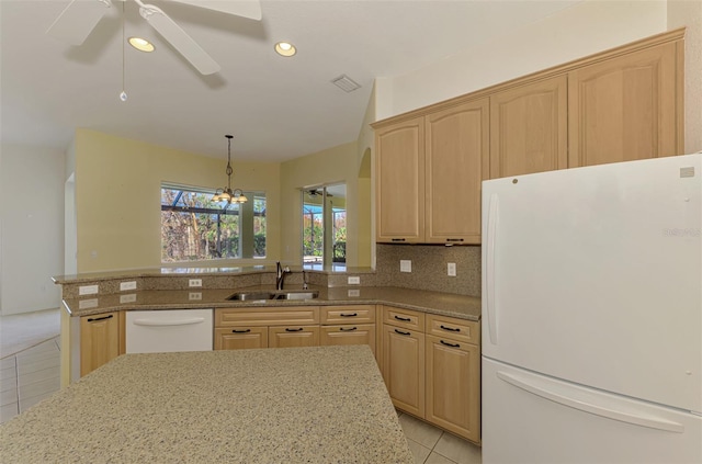 kitchen featuring white appliances, light brown cabinetry, sink, and ceiling fan with notable chandelier