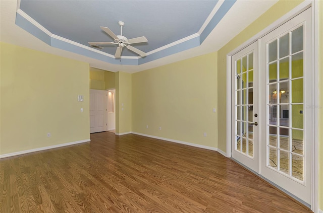 spare room featuring french doors, hardwood / wood-style flooring, ornamental molding, and a tray ceiling