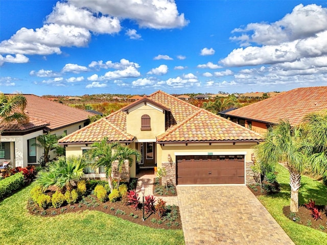 mediterranean / spanish-style home with a front lawn and a garage