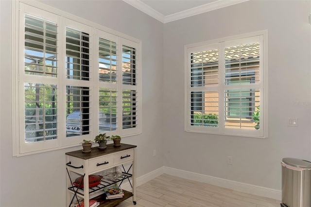 interior space with crown molding, light wood-type flooring, and plenty of natural light