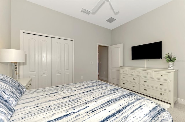 carpeted bedroom featuring a closet and ceiling fan