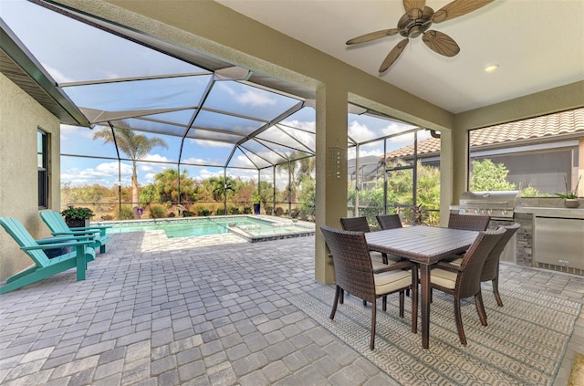 view of patio / terrace featuring area for grilling, ceiling fan, glass enclosure, and a grill