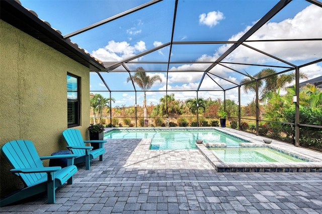 view of swimming pool with a patio, a lanai, and an in ground hot tub