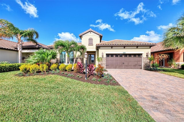 mediterranean / spanish-style home with a front lawn and a garage