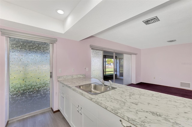 kitchen with white cabinets, sink, and dark hardwood / wood-style floors