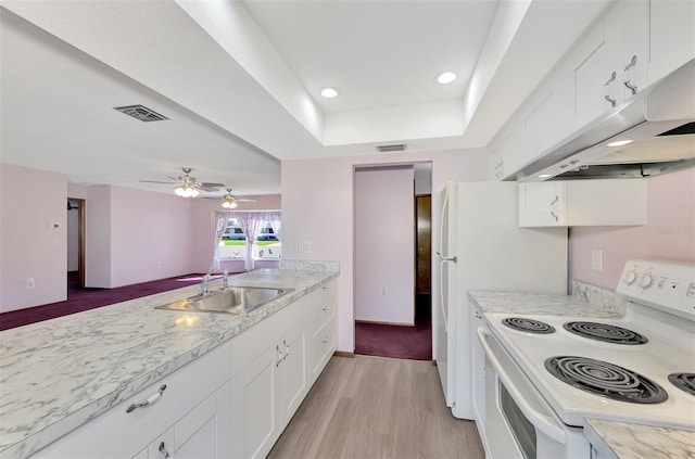 kitchen with white cabinets, a tray ceiling, light hardwood / wood-style flooring, white electric stove, and sink