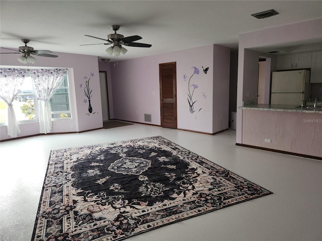 living room featuring ceiling fan and sink