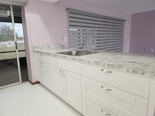 kitchen with white cabinetry and sink