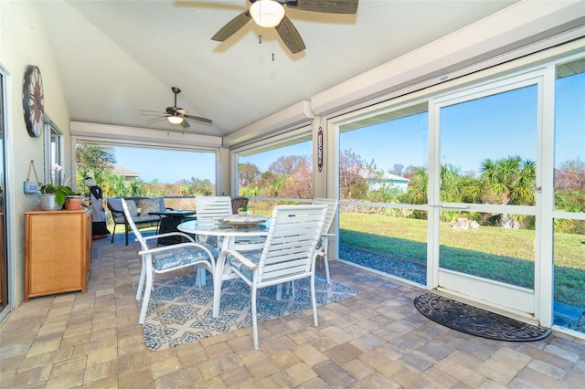 sunroom / solarium featuring lofted ceiling and ceiling fan