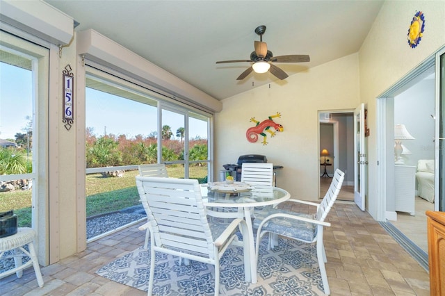 sunroom / solarium featuring ceiling fan and lofted ceiling