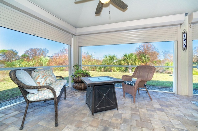 sunroom featuring ceiling fan and a wealth of natural light