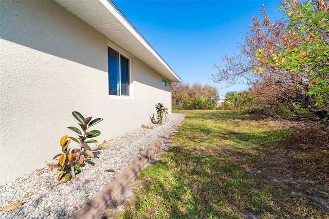 view of property exterior with a lawn