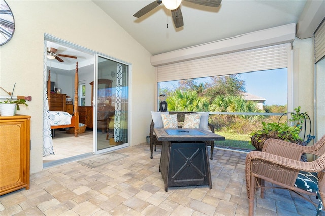 sunroom / solarium featuring ceiling fan and vaulted ceiling