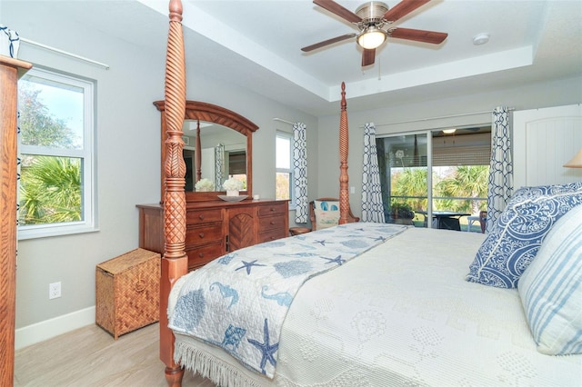 bedroom featuring ceiling fan, access to outside, and multiple windows