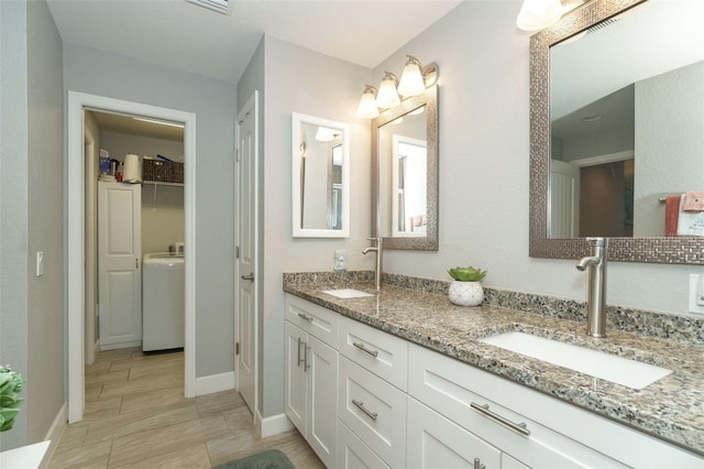 bathroom featuring washer / dryer and vanity