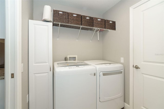 laundry area featuring washing machine and clothes dryer