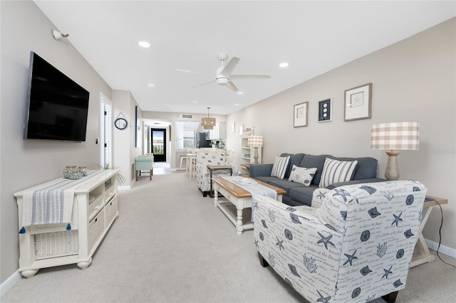 living room with ceiling fan and light colored carpet