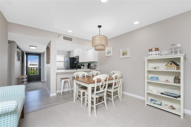 dining space with light wood-type flooring