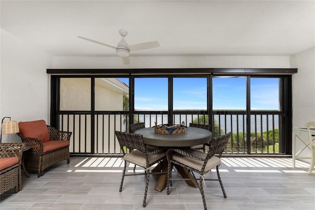 sunroom / solarium featuring ceiling fan