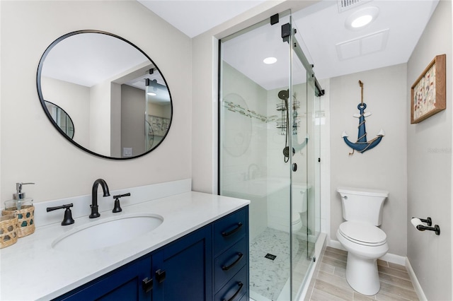 bathroom featuring vanity, toilet, and walk in shower