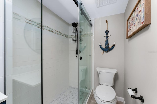 bathroom with toilet and an enclosed shower