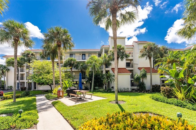 surrounding community with a yard and a patio area